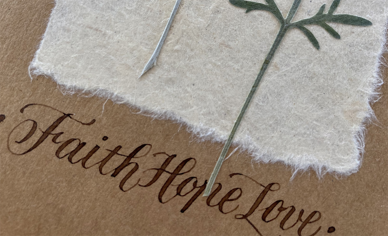 Card with a pressed stem and Faith Hope Love calligraphy