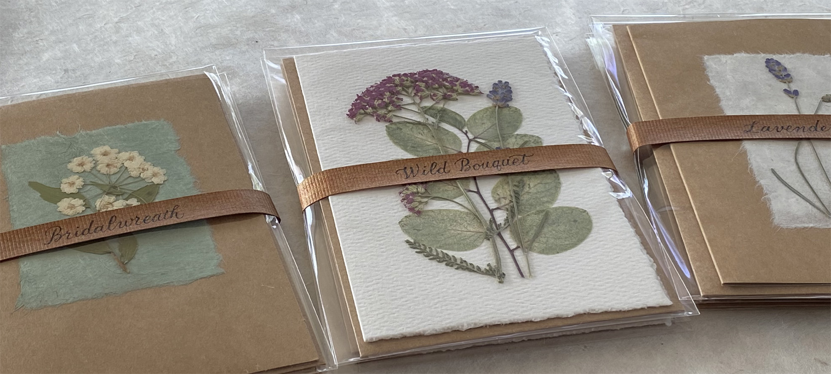 Pressed flower cards wrapped in copper ribbon