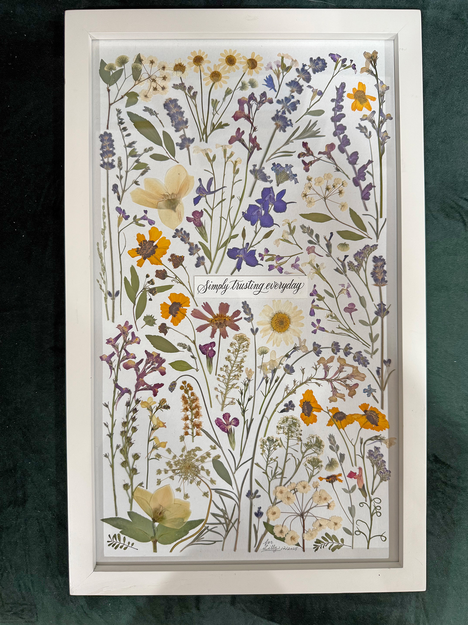 Wildflower composition with the words Simply trusting everyday in a white frame
